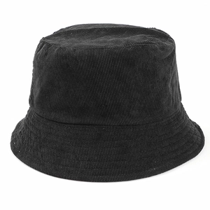 Detailed macro view of a black corduroy bucket hat showing the fine ribbed fabric texture
