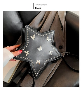 Detail of star-shaped black rivet bag featuring silver butterfly metal ornaments