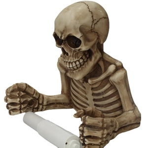 Detail view of the vintage resin skeleton skull wall mounted toilet paper roll holder