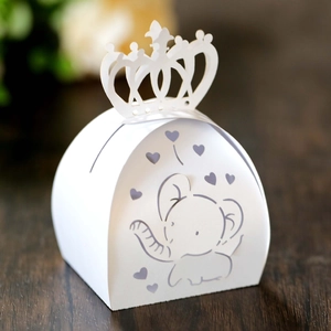 Detail of white paper candy box with laser-cut elephant and crown hollow patterns