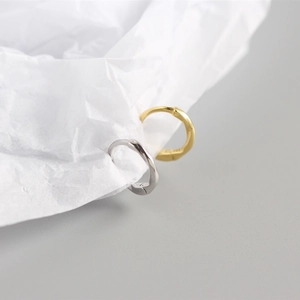 Close-up of S925 sterling silver knotted hoop earrings in gold and silver finishes