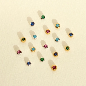 Flat lay of colorful round zircon stud earrings with gold and silver s925 silver needles