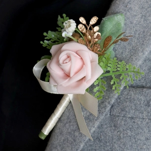 Pink PE rose boutonniere with gold leaf and ribbon for groom on grey suit lapel
