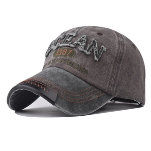 Macro detail of 3D OCEAN embroidery on vintage washed cotton baseball cap with stitching