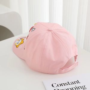 Detailed view of pink cotton baseball cap featuring star and cat prints with velcro strap