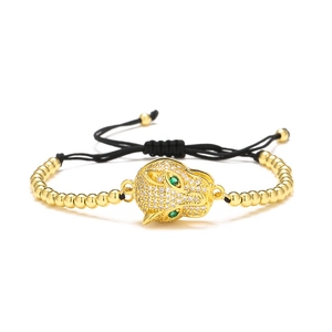 Detail of 18K gold plated leopard head bracelet with green eyes and white zircon stones