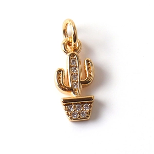 Detail of a gold-plated cactus pendant encrusted with sparkling clear zircon crystals