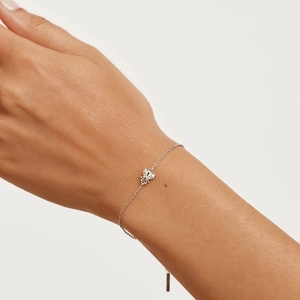 Detailed macro view of S925 sterling silver bee bracelet with cubic zirconia on female wrist