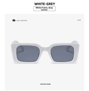 Detail view of stylish white rectangular sunglasses with dark grey lenses in a retro design