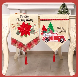 Detail of Christmas table runner with festive poinsettia print and Merry Christmas text