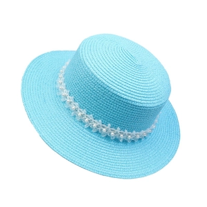 Top-down view of sky blue straw flat hat with elegant pearl lace ribbon detail