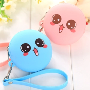 Detail of round silicone coin purses in blue and pink with cute cartoon faces