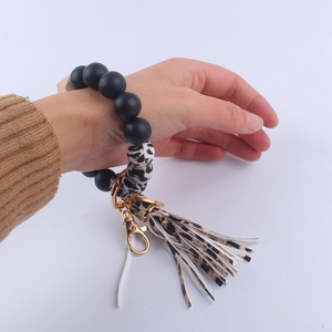 Beaded wristlet keychain with leopard print silicone beads and black leather tassel