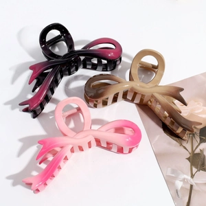 Three gradient butterfly hair claws in purple, brown, and pink with smooth resin finish