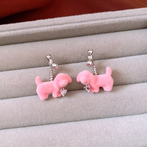 Detail of pink flocked puppy earrings with heart-shaped zircon and silver needles