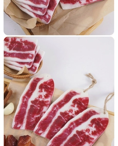 Detailed macro view of realistic PVC faux beef slices with hanging ropes for decor