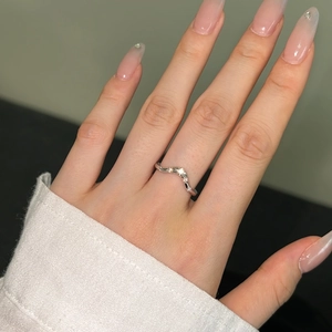 Detailed close-up of a silver V-shaped wave ring with pave-set sparkling zircons
