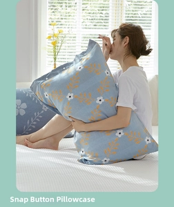 Detail of light blue floral cotton pillowcase showing unique snap button closure mechanism
