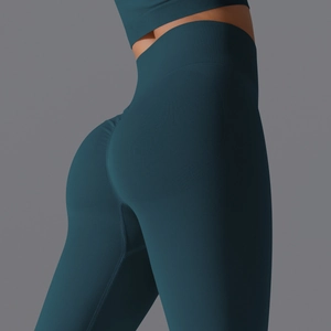 Detailed close-up of teal high-waist yoga pants featuring scrunch butt and ribbed waistband