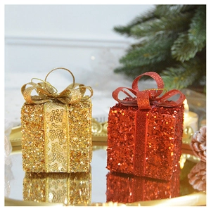 Close-up of glittery red and gold Christmas gift box ornaments with shiny sequins