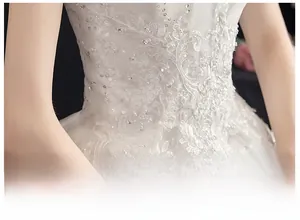 Macro detail of bridal gown waist featuring 3D lace floral embroidery and sparkling sequins