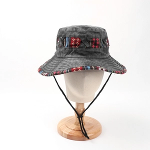 Detail of grey washed denim bucket hat with ethnic woven band and adjustable chin strap