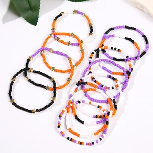Detail view of handmade Halloween beaded bracelet set with orange and black stars