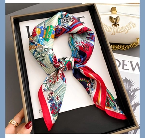 Detail of luxury silk scarf with vibrant floral patterns and elegant knotted styling