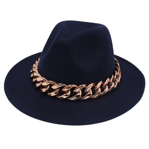Close-up of navy blue wool fedora featuring a bold rose gold metallic chain band