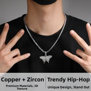 Close-up of hip hop style silver butterfly pendant with cubic zirconia on model