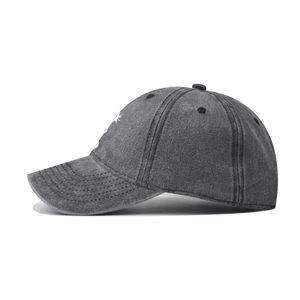 Detail of grey washed cotton baseball cap featuring contrast stitching and vintage style