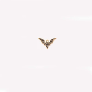 Macro shot of bronze gothic bat pendant with black enamel wings for DIY jewelry