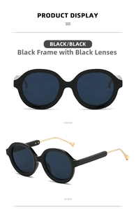 Detail view of retro round sunglasses with black frames and slim gold metal temples