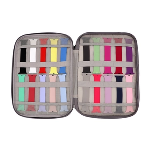 Internal view of grey watch band organizer case with multiple colorful silicone straps