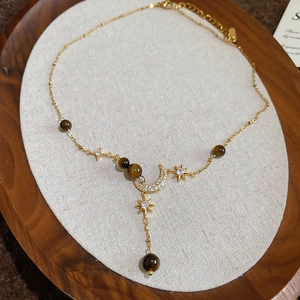 Vintage golden necklace with crescent moon, star charms and brown tiger eye stone pendant