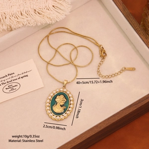 Detailed view of an oval gold portrait pendant with pearls on a stainless steel chain