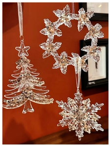 Detailed view of clear acrylic Christmas ornaments with gold glitter and silver hanging cords