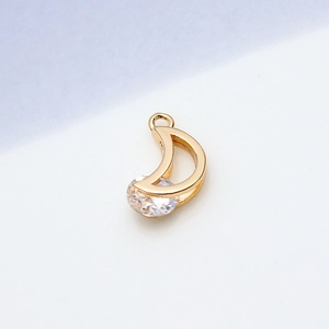 Detailed view of crescent moon pendant with sparkling zircon in bright gold finish