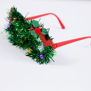 Detail of Christmas tinsel glasses with colorful bells and mini stockings on red frames