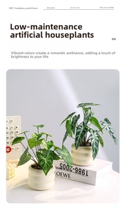 Detail of faux Alocasia plants with white veins in textured beige ceramic pots