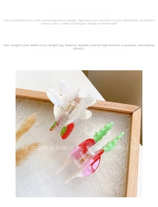 Detail view of acetate hair claw clips measuring 9.2cm by 4.1cm in rabbit and strawberry motifs