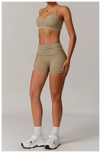 Full body view of khaki recycled yoga sports bra and high-waisted gym shorts set
