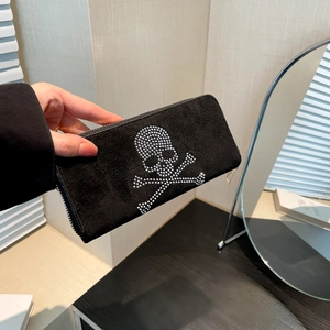 Women's black suede long wallet featuring a silver-studded skull and zip-around closure