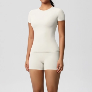 Detail of high-elasticity ribbed knit fabric on beige two-piece yoga set for women