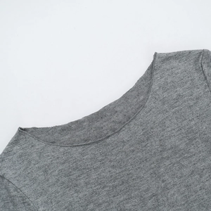 Close-up detail of the crew neckline and knit texture on this gray long sleeve top