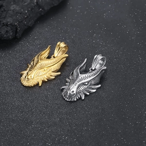 Close-up of punk style dragon head pendants in gold and silver vacuum-plated titanium steel