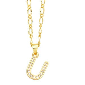 Close-up of gold-plated letter U pendant featuring shimmering cubic zirconia on a Figaro chain