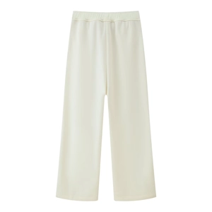 Detailed view of the elastic waist and knit texture on cream wide-leg lounge pants