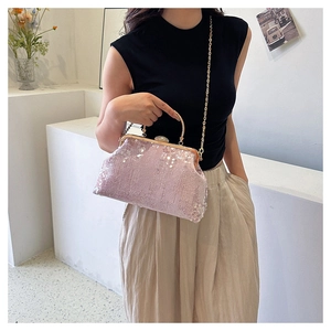 Pink sequin evening bag featuring a gold chain strap and metallic circular handle