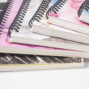 A5 thick spiral notebook with pink ink and marble texture covers and black wire-o binding